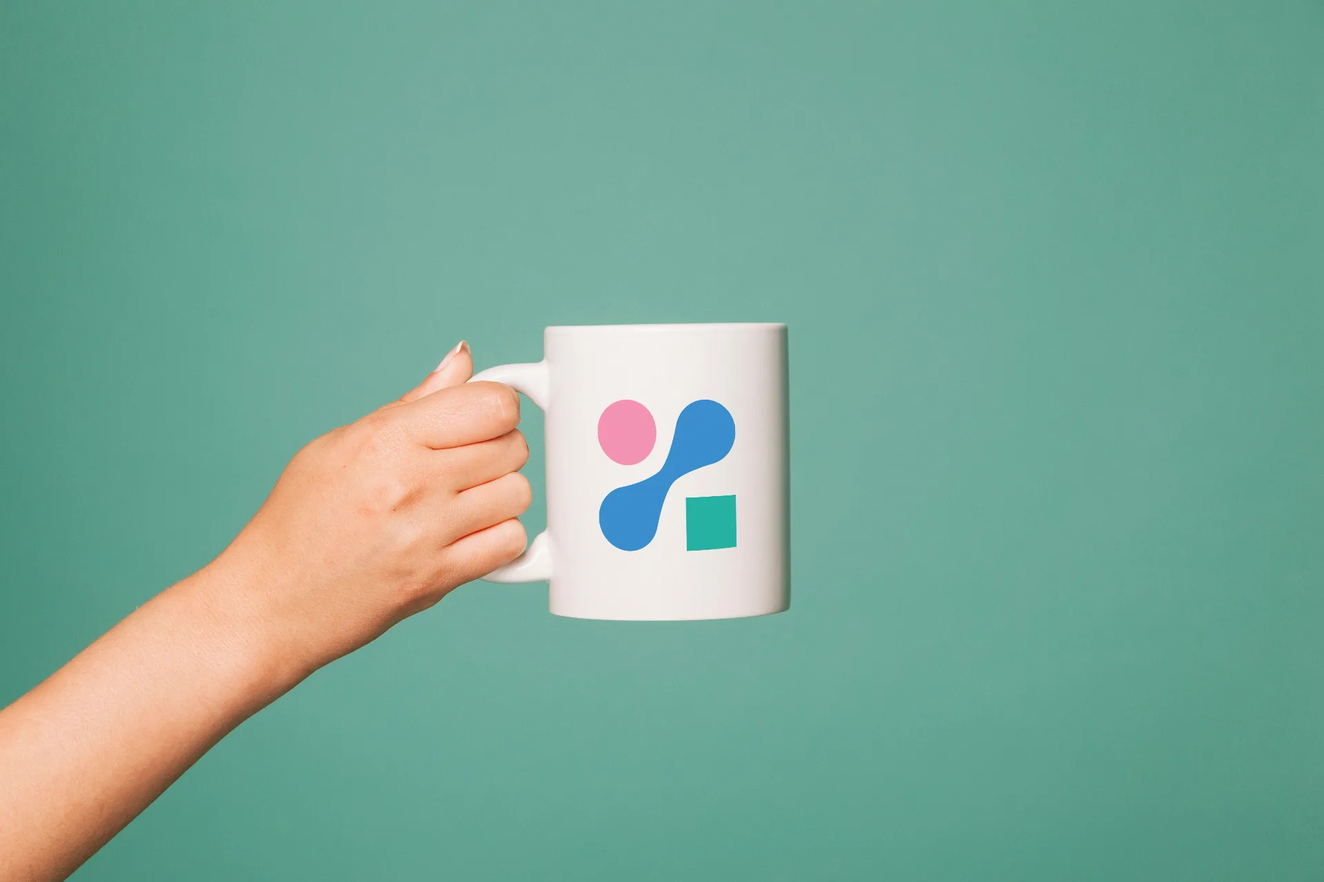 2X Digital branded mug with pink and blue chromosome logo on teal background
