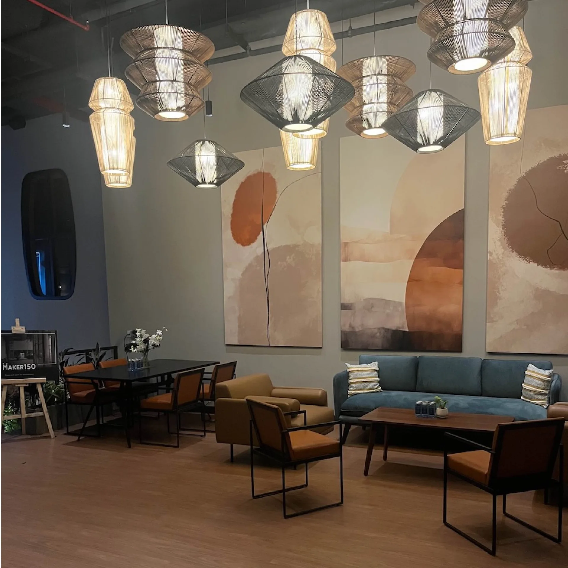 District 150 - Collaborative workspace with pendant lighting and artistic wall murals