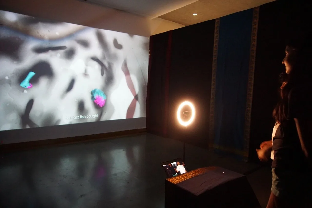 Give Me a Sign - Dark room installation with 'the last fish caught' projection