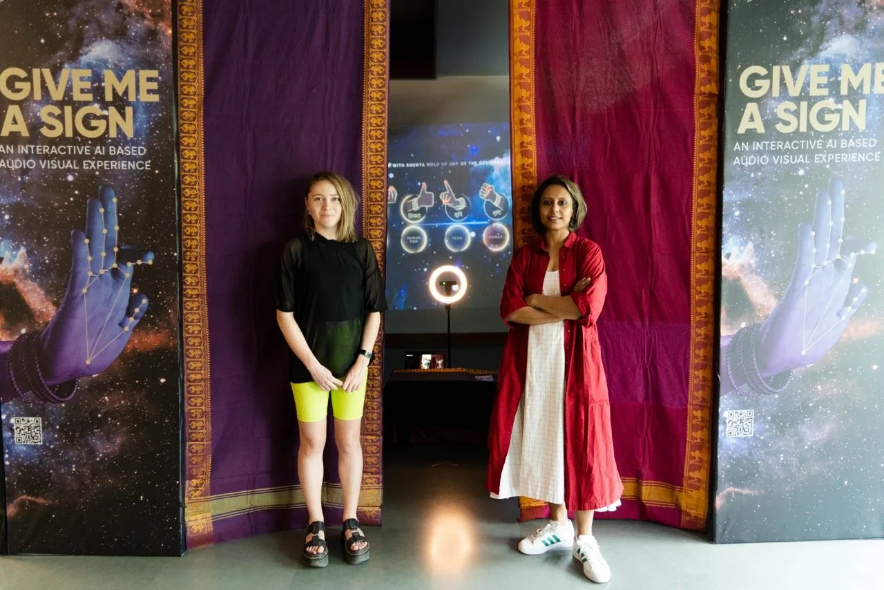 Give Me a Sign - Artists at installation entrance with Shunya interface visible