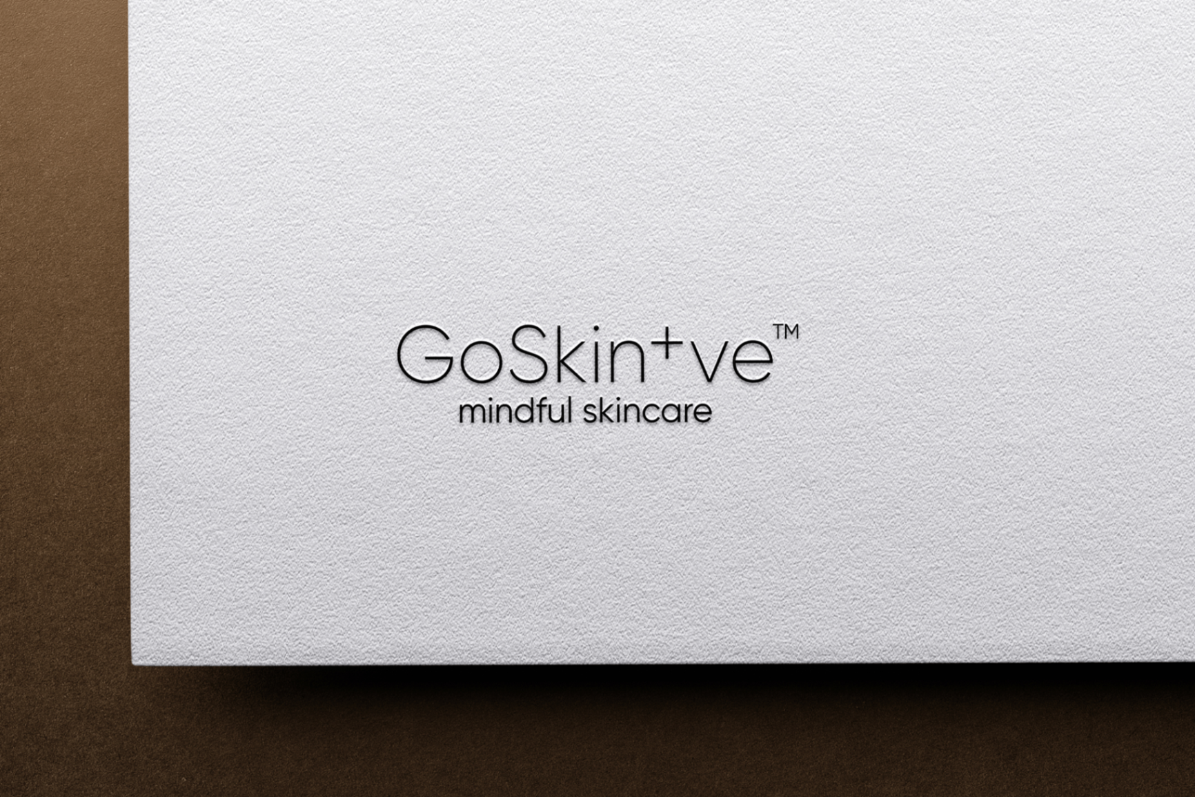 GoSkin+ve embossed logo on textured paper showcasing mindful skincare brand identity