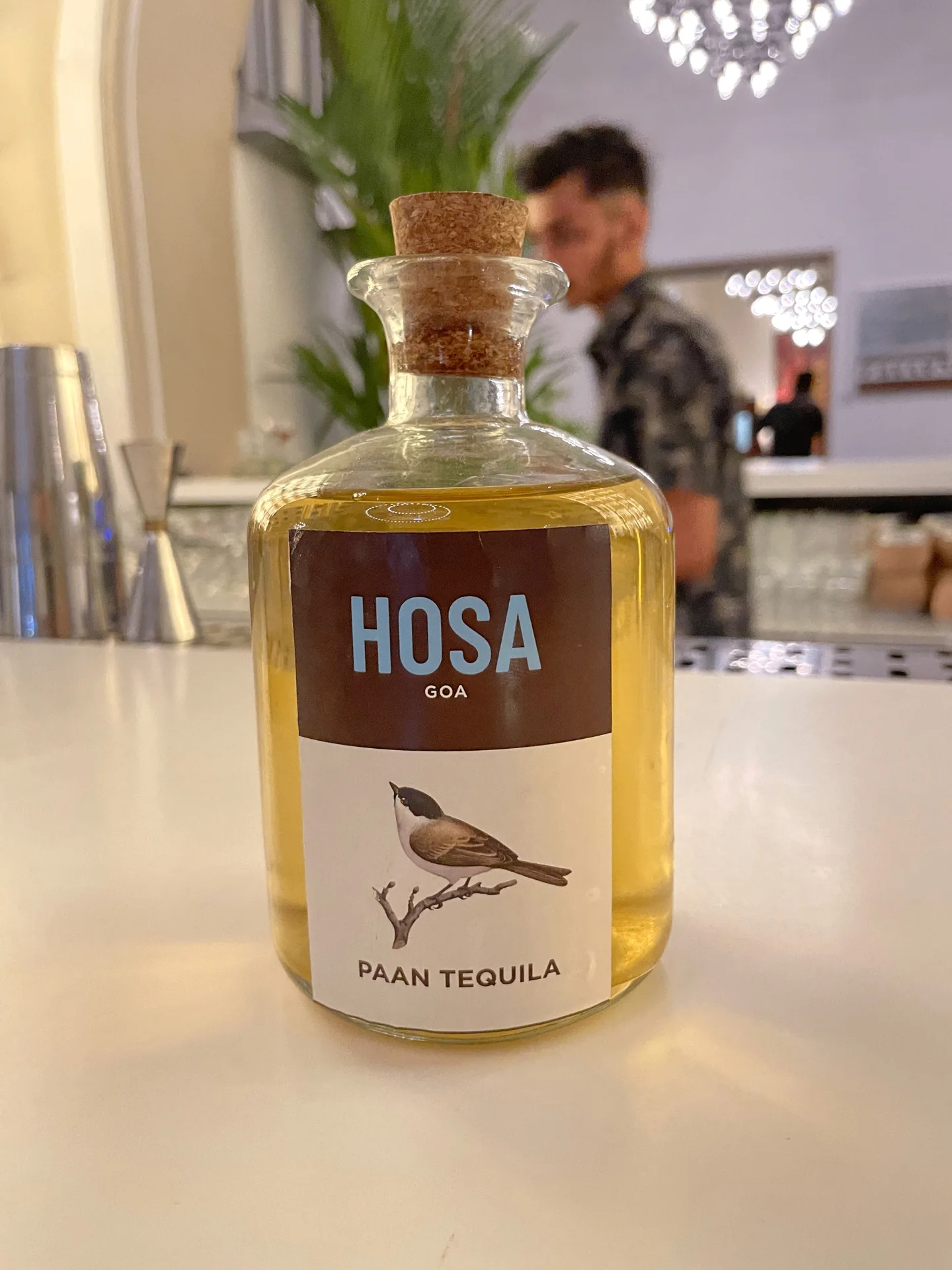 HOSA GOA - Branded Paan Tequila bottle with bird illustration and restaurant branding