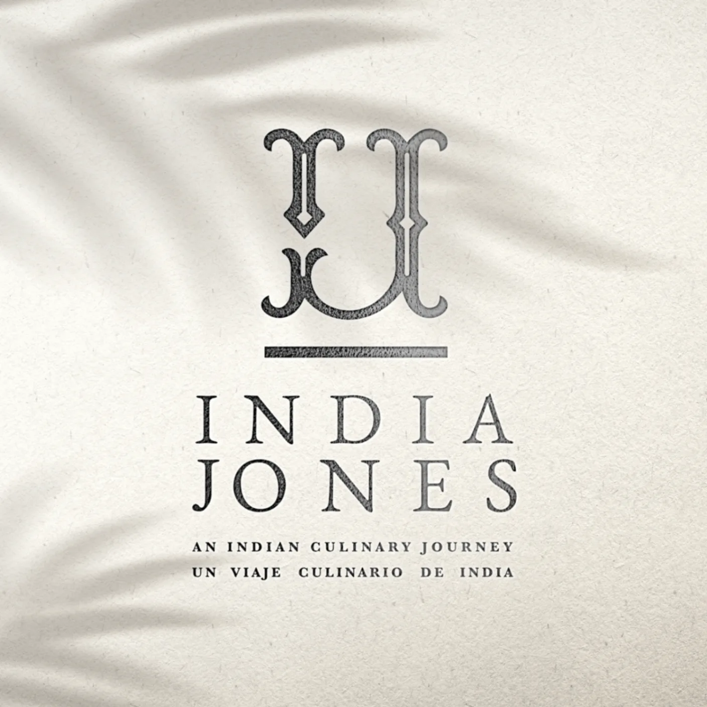 India Jones - Embossed black logo design on textured surface