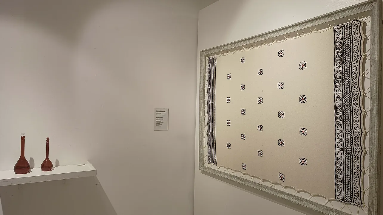 Traditional textile pattern display featuring geometric designs in contemporary gallery setting